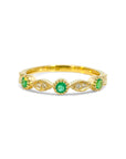 Anillo cintillo esmeraldas y diamantes en ojitos ruleteados