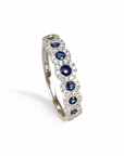 Anillo Cintillo de 7 Zafiros en Halo de Brillantes