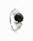 Anillo tricillo Sophia Schneider Joyas de platino con turmalina negra central y zafiros blancos laterales.