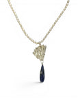Sophia Schneider Joyas Maris necklace with pearls, lapis lazuli, and silver. Features a faceted lapis lazuli drop and a textured silver pendant.