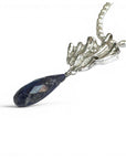 Sophia Schneider Joyas Maris necklace with pearls, silver, and lapis lazuli pendant. Textured silver pendant with a faceted teardrop lapis lazuli.