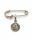 Sophia Schneider Joyas silver safety pin brooch with guardian angel charm. Sterling silver, 3.8cm total length.