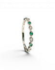 Sophia Schneider Joyas 14K white gold ring with alternating emeralds and diamonds, delicate band.