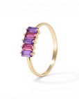 Sophia Schneider Joyas 14K gold ring with alternating amethyst and rhodolite baguette-cut stones.