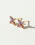 Sophia Schneider Joyas 14K gold earrings with marquise-cut amethyst and rhodolite stones in a floral design.