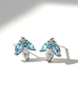 Sophia Schneider Joyas 14K gold earrings with marquise-cut blue topaz and white cz stones, delicate floral design.