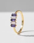 Sophia Schneider Joyas 14K gold ring with alternating baguette-cut iolite and clear zircon stones.