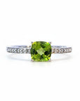 Sophia Schneider Joyas 14K gold ring with cushion-cut peridot and 0.62 ct diamonds on band.