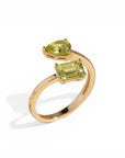 Sophia Schneider Joyas 14K gold ring with two peridot stones, one pear-cut and one emerald-cut.