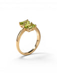 Sophia Schneider Joyas 14K gold ring with two emerald-cut peridot stones.