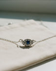 Sophia Schneider Joyas 14K gold evil eye necklace with sapphire and 0.19 ct diamonds.
