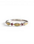 Sophia Schneider Joyas 14K gold ring with alternating yellow sapphires and red rubies, delicate gemstone band.