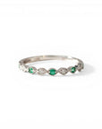 Sophia Schneider Joyas 14K white gold band ring with alternating emeralds and diamonds in a scalloped setting.