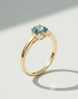 Sophia Schneider Joyas 18K yellow gold ring with a round 0.96 ct blue topaz center stone.
