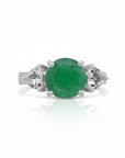 Sophia Schneider Joyas sterling silver ring with a central oval green emerald and two pear-cut white topaz stones.