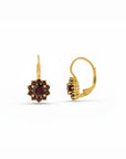 Sophia Schneider Joyas 14K gold dangle earrings featuring a central round garnet surrounded by ten smaller garnets in a floral halo design.