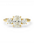 Sophia Schneider Joyas 18K yellow gold ring with a 1.08 ct oval lab-created diamond center stone and two round side stones.