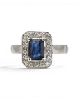 Sophia Schneider Joyas platinum halo ring with emerald-cut sapphire and 0.18 ct diamonds.
