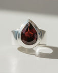 Sophia Schneider Joyas silver ring with a 6.53 ct pear-cut garnet gemstone.
