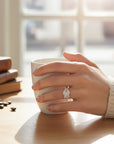 Sophia Schneider Joyas silver ring with carved leaf design and cubic zirconia accents.