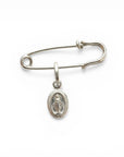 Sophia Schneider Joyas silver safety pin brooch with a Miraculous Medal charm featuring the Virgin Mary.