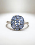 Sophia Schneider Joyas silver ring with oval and pear-shaped tanzanite stones arranged in a floral pattern.
