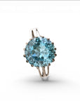Sophia Schneider Joyas silver ring with a large, round, faceted sky blue topaz gemstone.