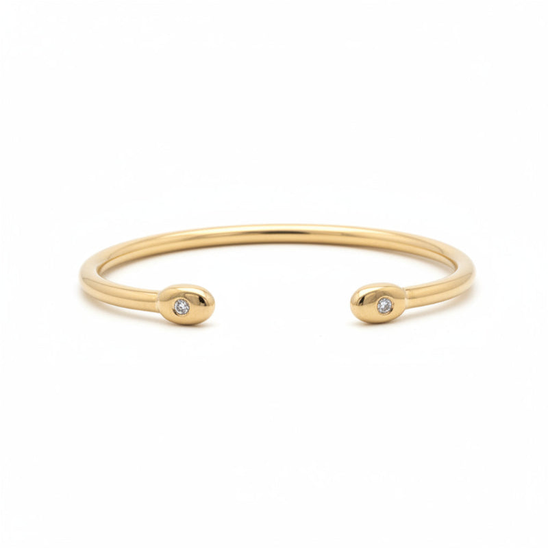Esclava abierta tubular oro 18K diamantes en bisel