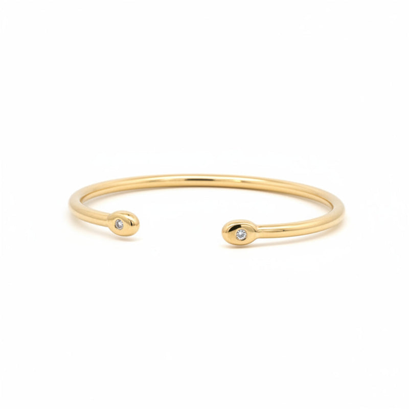 Esclava abierta tubular oro 18K diamantes en bisel