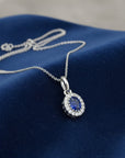 Sophia Schneider Joyas 14K white gold oval sapphire halo diamond pendant necklace.