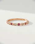 Sophia Schneider Joyas 14K rose gold ring with alternating rubies and 0.09 ct diamonds in a delicate band.