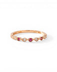 Sophia Schneider Joyas 14K rose gold ring with alternating rubies and 0.09 ct diamonds in a delicate band.