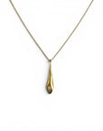 Sophia Schneider Joyas gold teardrop pendant necklace with a small diamond accent on a delicate chain.