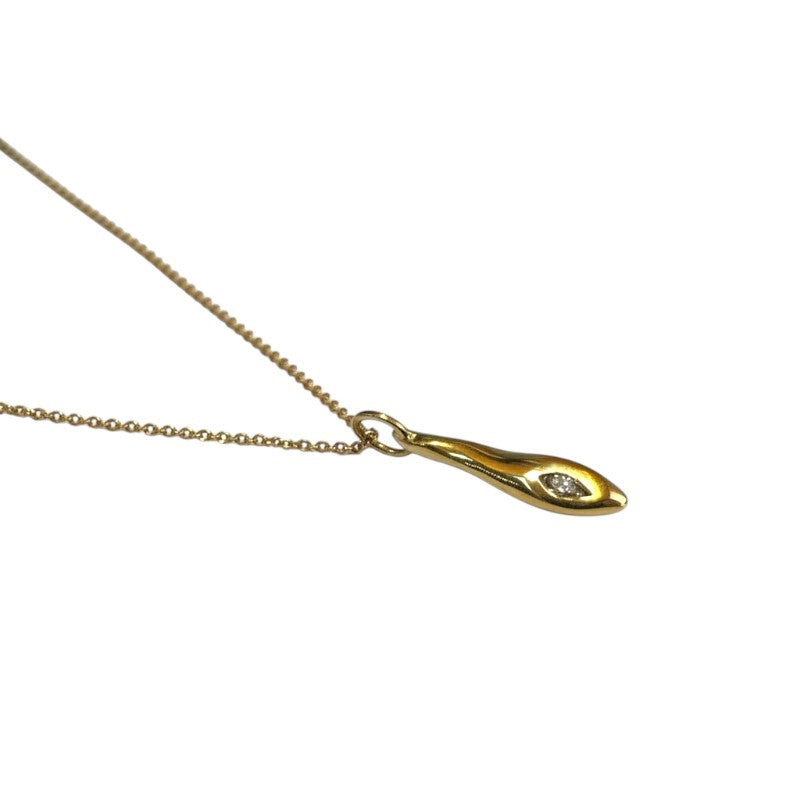 Sophia Schneider Joyas gold pendant necklace with a single diamond accent, featuring an abstract, elongated teardrop shape.