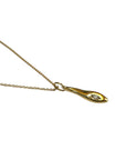 Sophia Schneider Joyas gold pendant necklace with a single diamond accent, featuring an abstract, elongated teardrop shape.