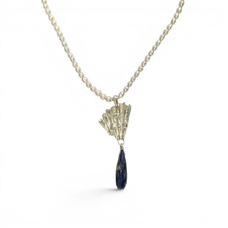 Sophia Schneider Joyas Maris necklace with pearls, lapis lazuli, and silver. Features a faceted lapis lazuli drop and a textured silver pendant.