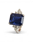 Sophia Schneider Joyas platinum ring with a large emerald-cut sapphire and surrounding diamonds.
