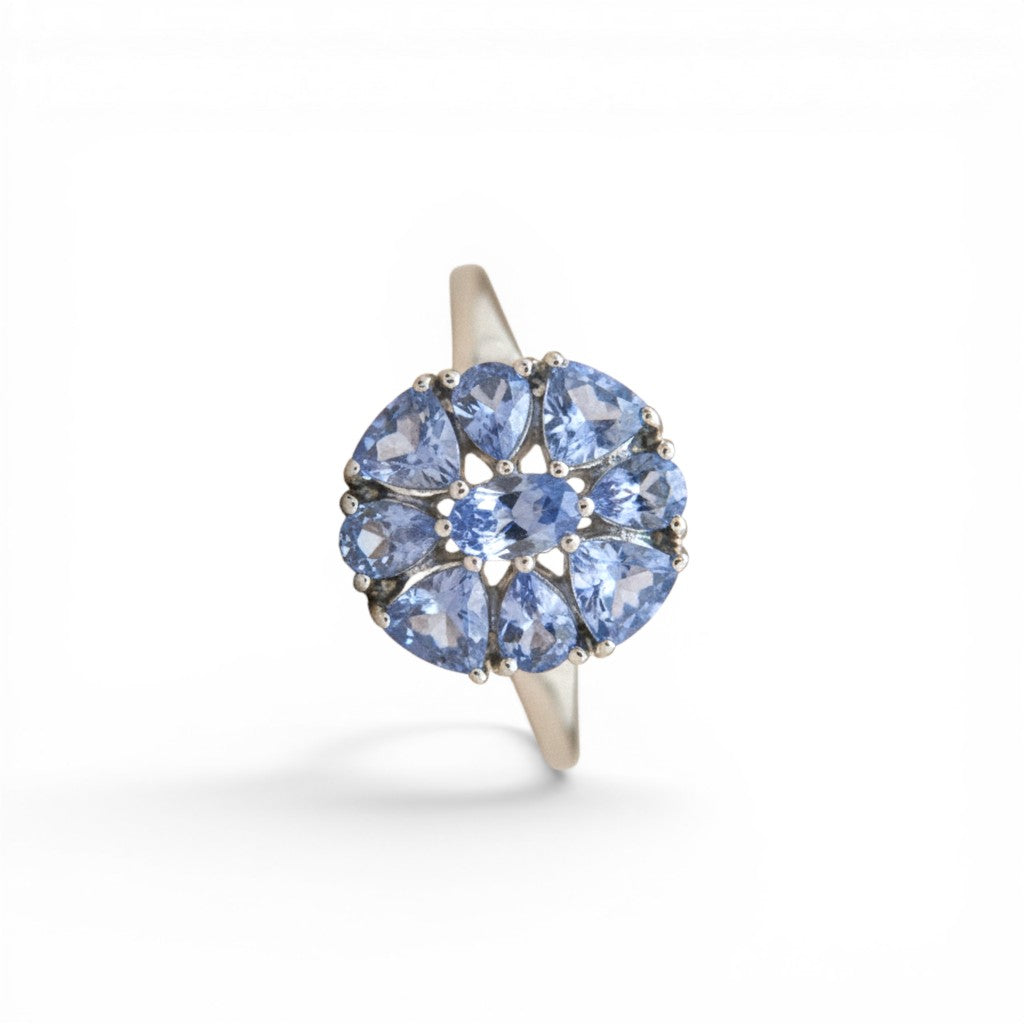 Sophia Schneider Joyas silver ring with a cluster of pear-shaped blue tanzanite stones in a floral design.