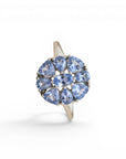 Sophia Schneider Joyas silver ring with a cluster of pear-shaped blue tanzanite stones in a floral design.
