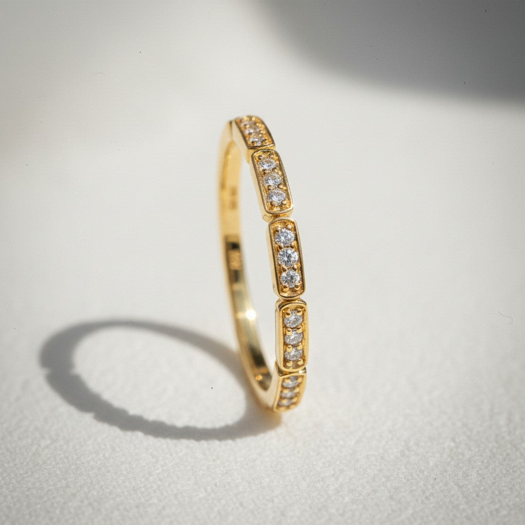 Sophia Schneider Joyas 10K yellow gold band ring with bezel-set diamonds totaling 0.125 ct.