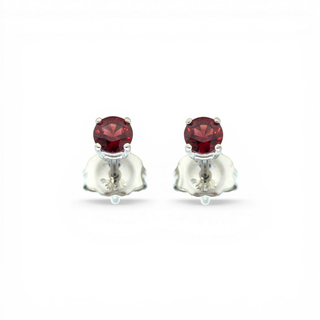 Sophia Schneider Joyas 10K white gold stud earrings with two oval-cut garnets.