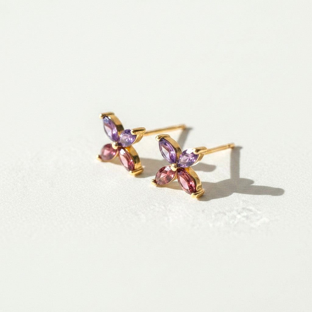 Sophia Schneider Joyas 14K gold earrings with marquise-cut amethyst and rhodolite stones in a floral design.