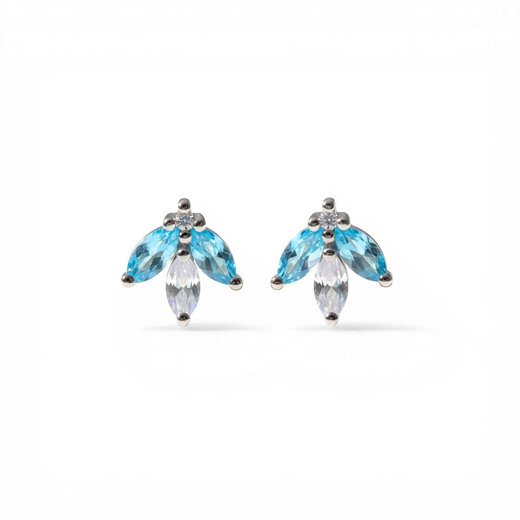 Sophia Schneider Joyas 14K gold earrings with marquise-cut blue topaz and white cz stones in a floral design.
