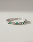 Sophia Schneider Joyas 14K white gold eternity band with alternating emeralds and diamonds.
