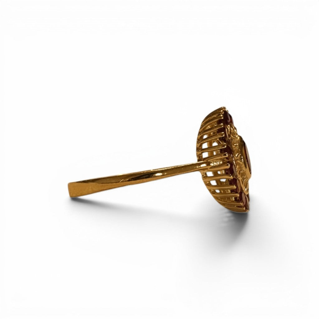 Sophia Schneider Joyas 14K gold ring with oval garnet center stone and halo of smaller garnets, floral design.