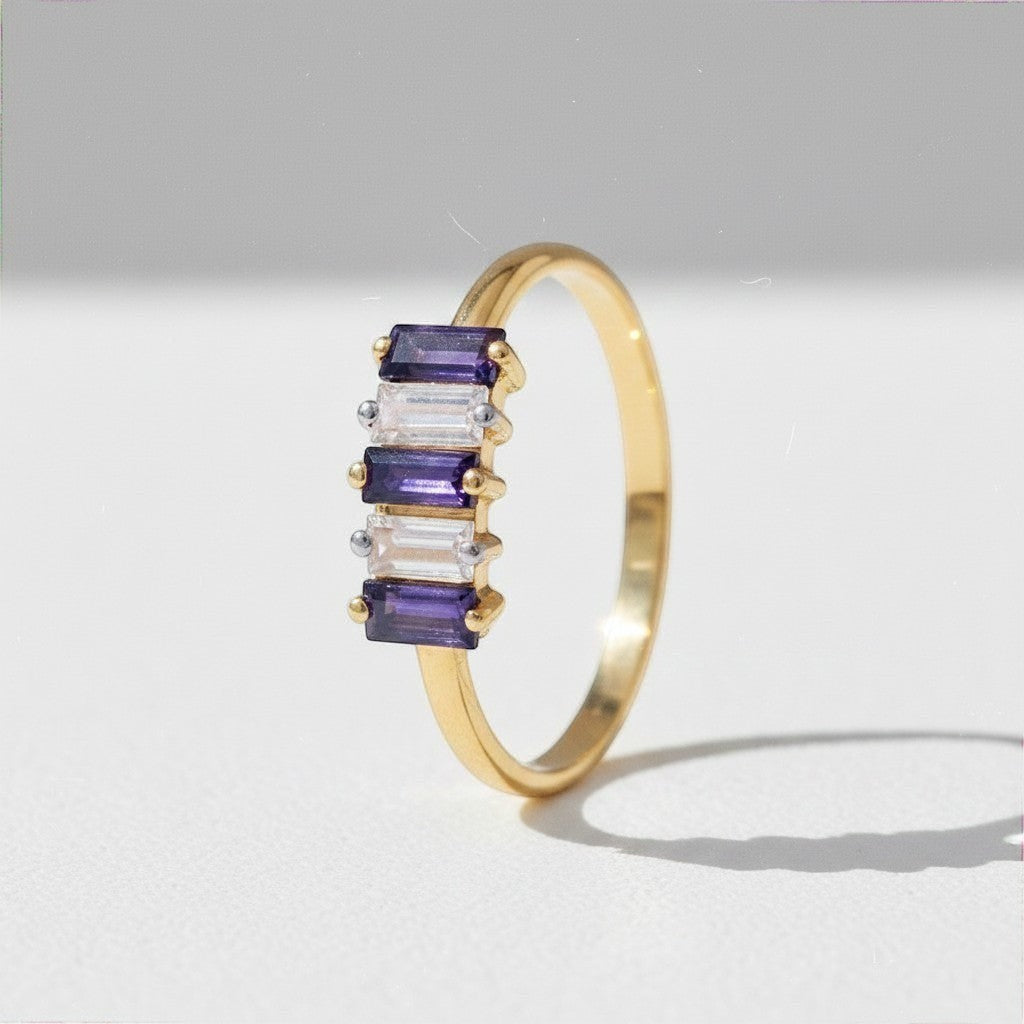 Sophia Schneider Joyas 14K gold ring with alternating baguette-cut iolite and clear zircon stones.