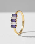 Sophia Schneider Joyas 14K gold ring with alternating baguette-cut iolite and clear zircon stones.