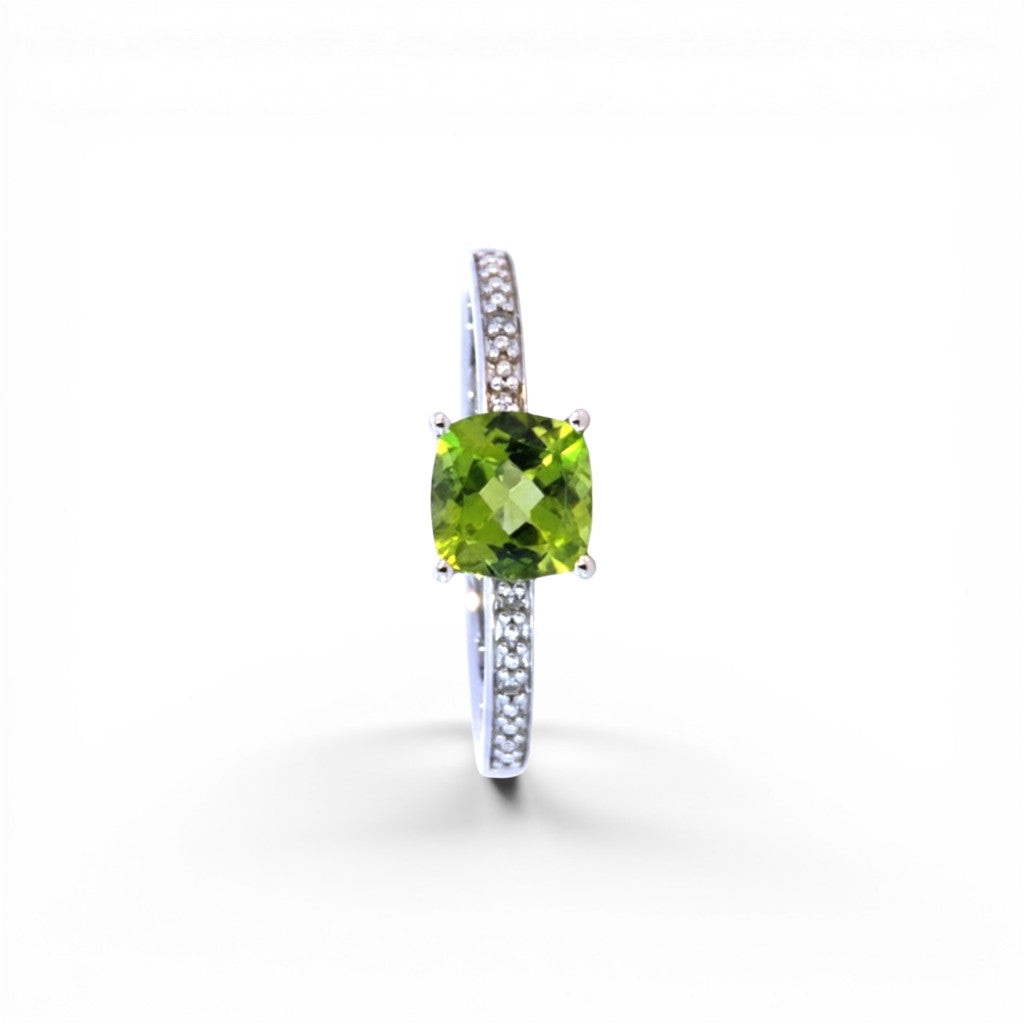 Sophia Schneider Joyas 14K gold ring with cushion-cut peridot and 0.62 ct diamonds on band.
