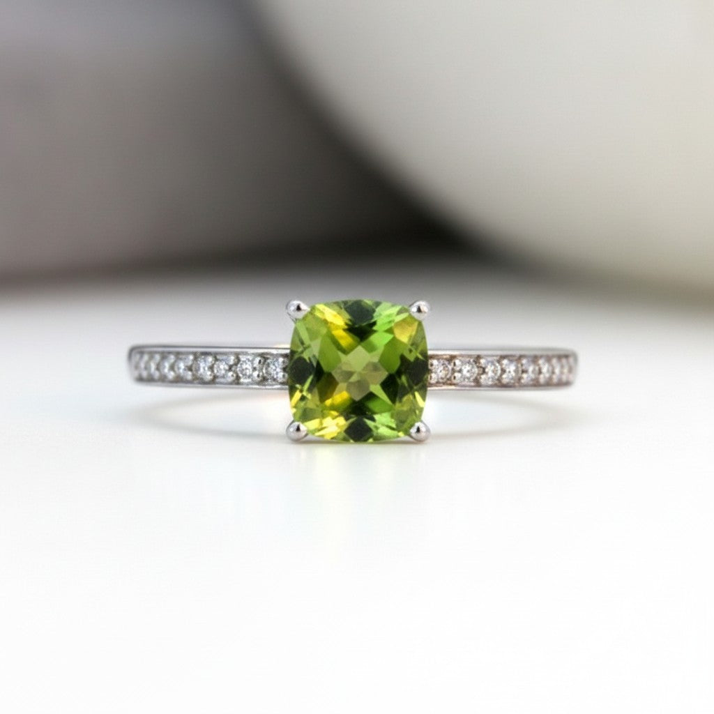 Sophia Schneider Joyas 14K gold ring with cushion-cut peridot and 0.62 ct diamonds on band.