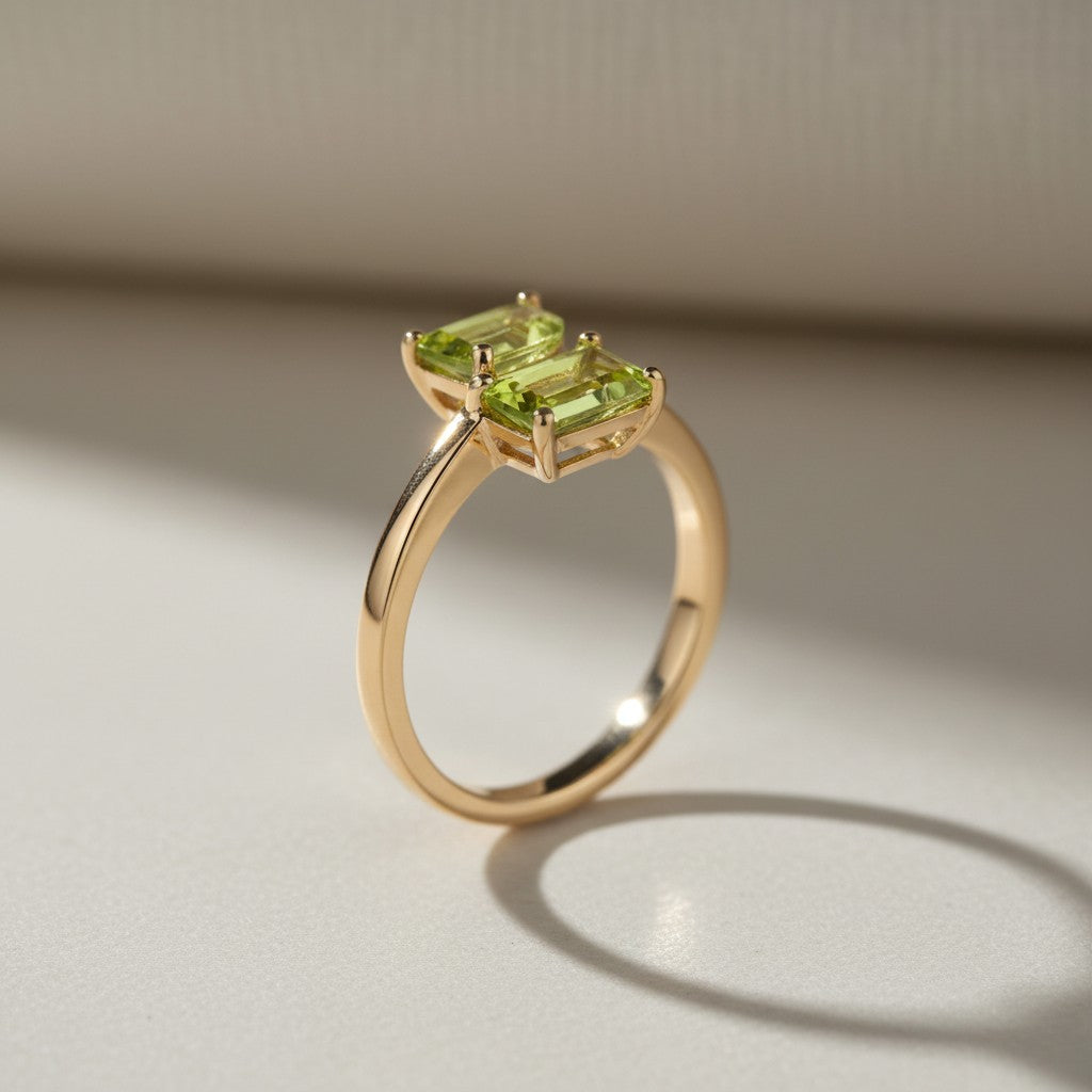 Sophia Schneider Joyas 14K gold ring with two marquise-cut peridot gemstones.